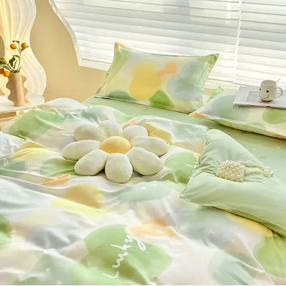 A plush white and yellow flower-shaped pillow on the bed from decorbites aloe cotton printed bedding set