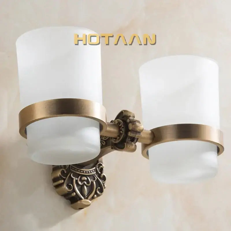 Decorbites aluminium double tumbler holder in antique brass finish with frosted glass shades for bathroom use