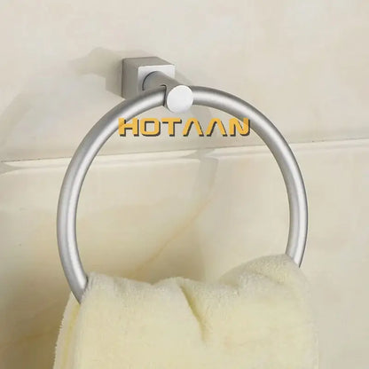 Silver-toned aluminium round towel holder ring with square base holding a cream towel for bathroom use