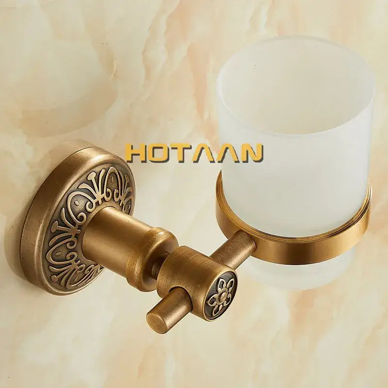 Decorbites™ aluminium single tumbler holder with antique brass finish, floral detailing, and frosted white cup holder