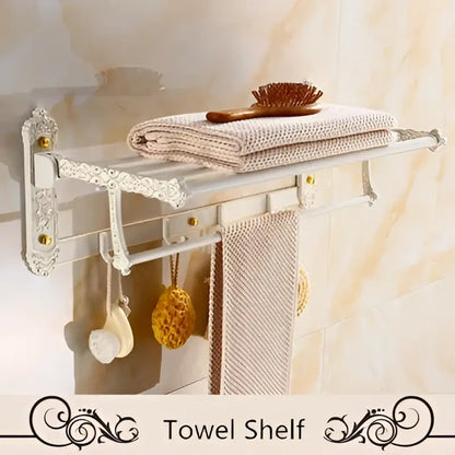 White ornate aluminum towel shelf with decorative scrollwork and gold-toned hardware in decorbites bath hardware set