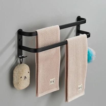 DecorBites aluminum bathroom towel rack with double-tier black wall-mounted design and beige textured towels hanging