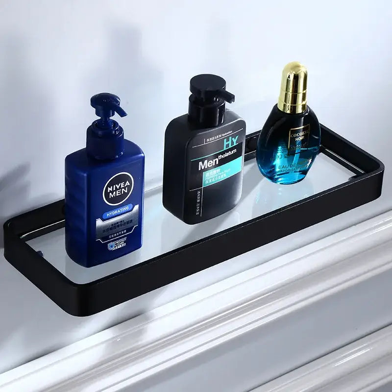 Black glass corner shelf with sleek aluminum frame holding three grooming products in decorbites bathroom hardware set