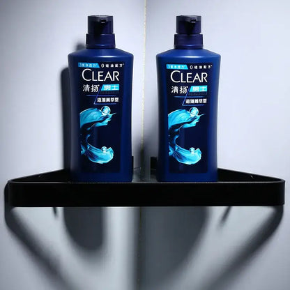 Two dark blue plastic bottles of clear men’s shampoo with glossy finish shown alongside decorbites™ aluminum black bathroom hardware set