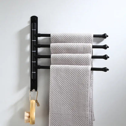 Black aluminum towel rack with four bars holding light gray towels from DecorBites bathroom hardware set