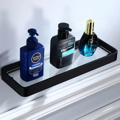 Black glass corner shelf with sleek aluminum frame holding three grooming products in bathroom hardware set