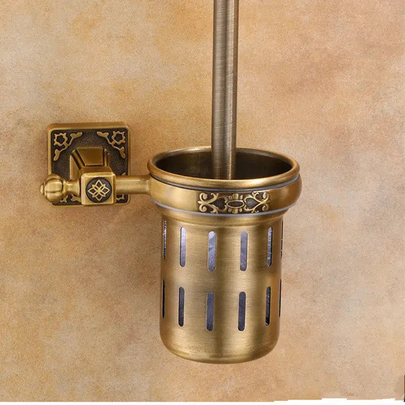 Antique brass decorbites aluminum carved toilet brush holder with ornate detailing and vertical slits for wall mounting