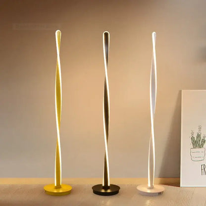 Three modern twist-design aluminum floor lamps in yellow gold and white with dimmable led lighting by decorbites