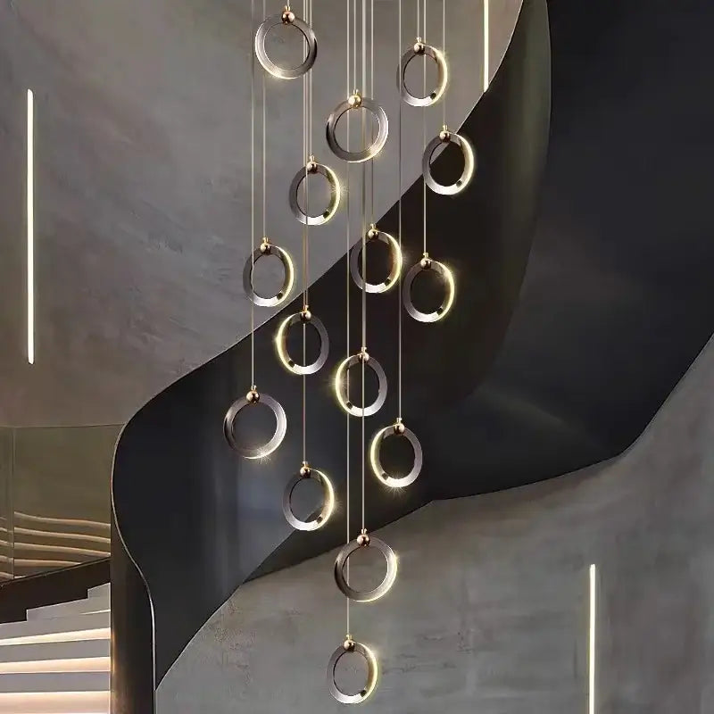 Modern minimalist aluminum led chandelier with polished metallic rings and warm ambient glow for luxury staircase lighting