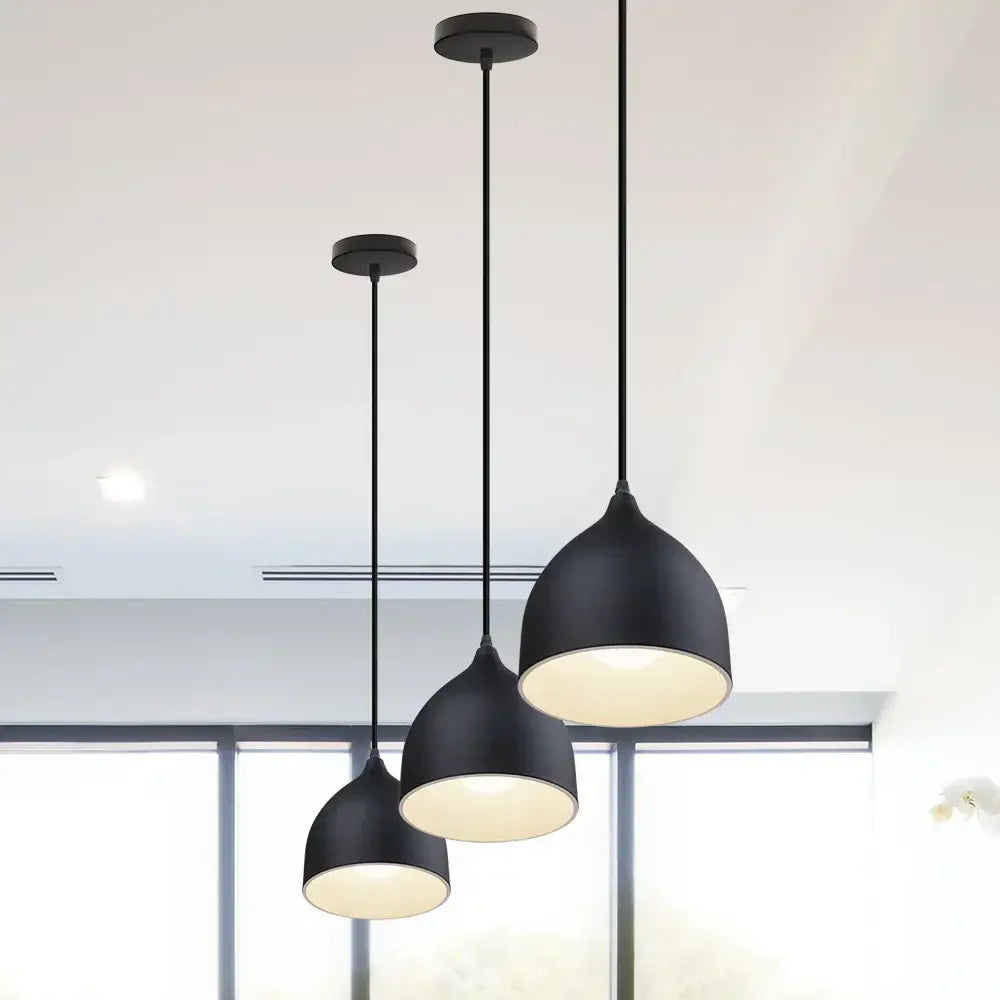 Set of three black matte aluminum led pendant lights with dome-shaped shades and warm glow for modern interiors
