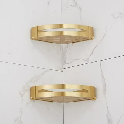 Gold-colored decorbites aluminum shower shelf with perforated surface and modern design for bathroom corners