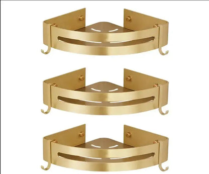 Gold-colored DecorBites aluminum shower shelf with two hooks and central cutout design for bathroom corner use