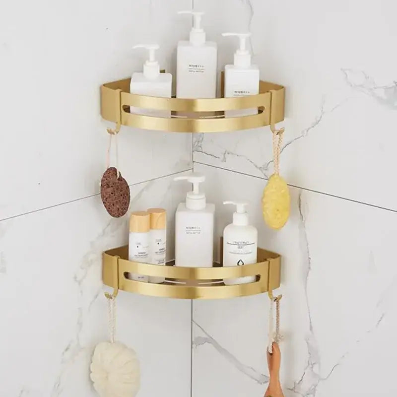 Gold-colored two-tiered decorbites aluminum shower shelf with brushed aluminum finish and open slotted design for bathroom corner
