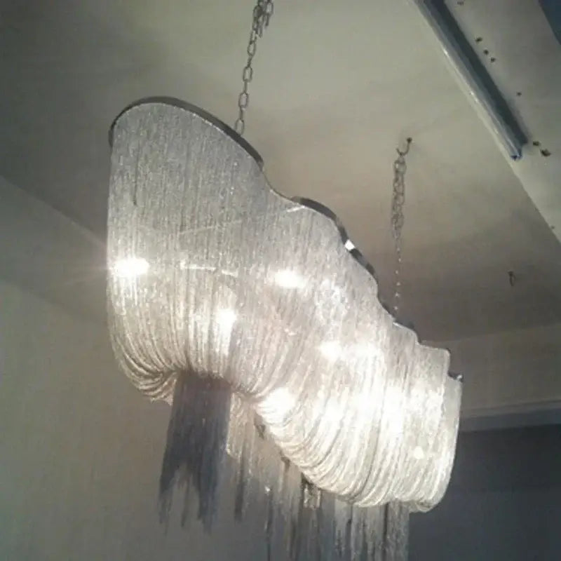 Decorbites aluminum tassel chandelier with curved metallic frame and cascading crystal strands for living room lighting