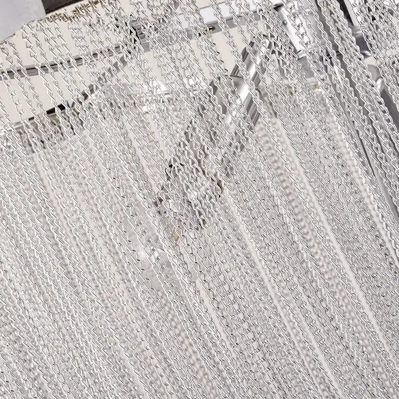 Silver metallic chain curtain with interlocking links creating a textured pattern in decorbites aluminum tassel chandelier