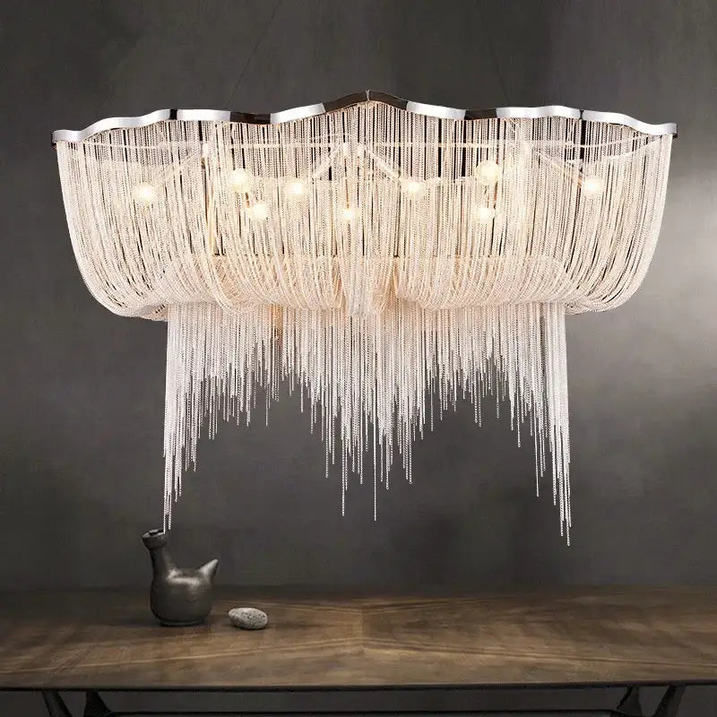 A modern white decorbites aluminum tassel chandelier with scalloped frame and cascading beads for living room light