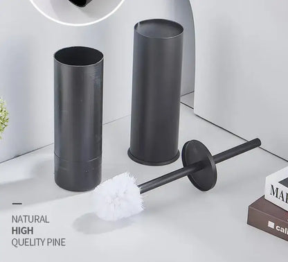 Decorbites™ aluminum toilet brush holder set in brushed gold and black featuring a black toilet brush with white bristles