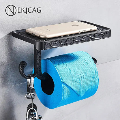 Black ornate aluminum toilet paper holder by DecorBites with a sleek phone rack shelf and hook holding keys
