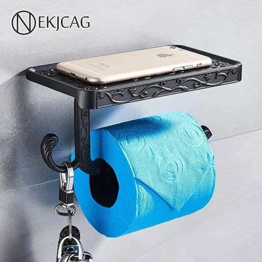 Black ornate aluminum toilet paper holder by DecorBites with a sleek phone rack shelf and hook holding keys