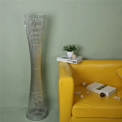 Silver metallic DecorBites aluminum tower floor lamp with tall slender twisted wireframe design for modern living room decor