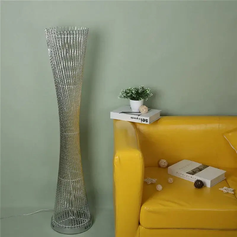 Silver metallic DecorBites™ aluminum tower floor lamp with slender twisted wireframe design for modern living room decor