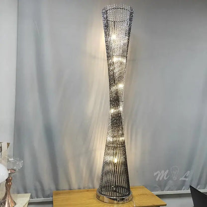 Tall slender decorbites aluminum tower floor lamp with twisted metallic frame and warm LED lights for living room use