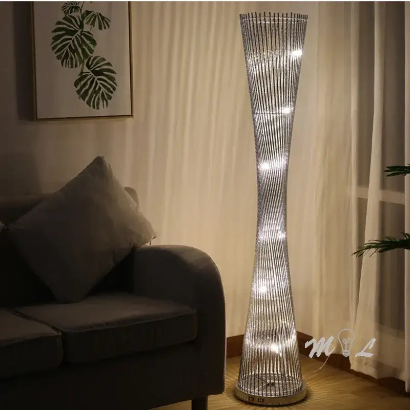 Silver slender decorbites aluminum tower floor lamp with twisted wireframe and embedded led lights for living room use