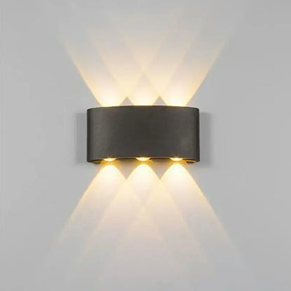 Modern black cylindrical decorbites aluminum wall lamp with three warm lights casting geometric patterns for living rooms