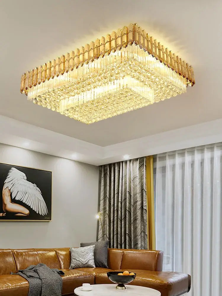 Gold-toned crystal round chandelier with amber crystal prisms and a modern elegant design for living room decor