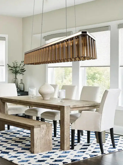 A modern rectangular amber glass chandelier with bronze-finished vertically slatted design for nordic dining room