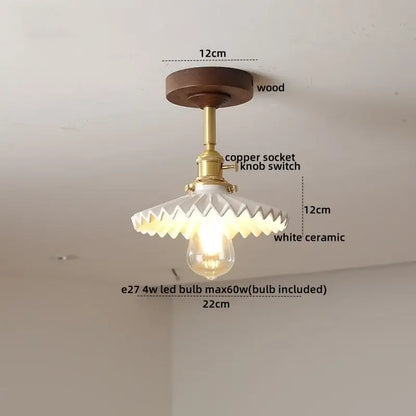 Vintage-style ceiling light fixture with dark wood base, brass copper socket, and white scalloped ceramic shade