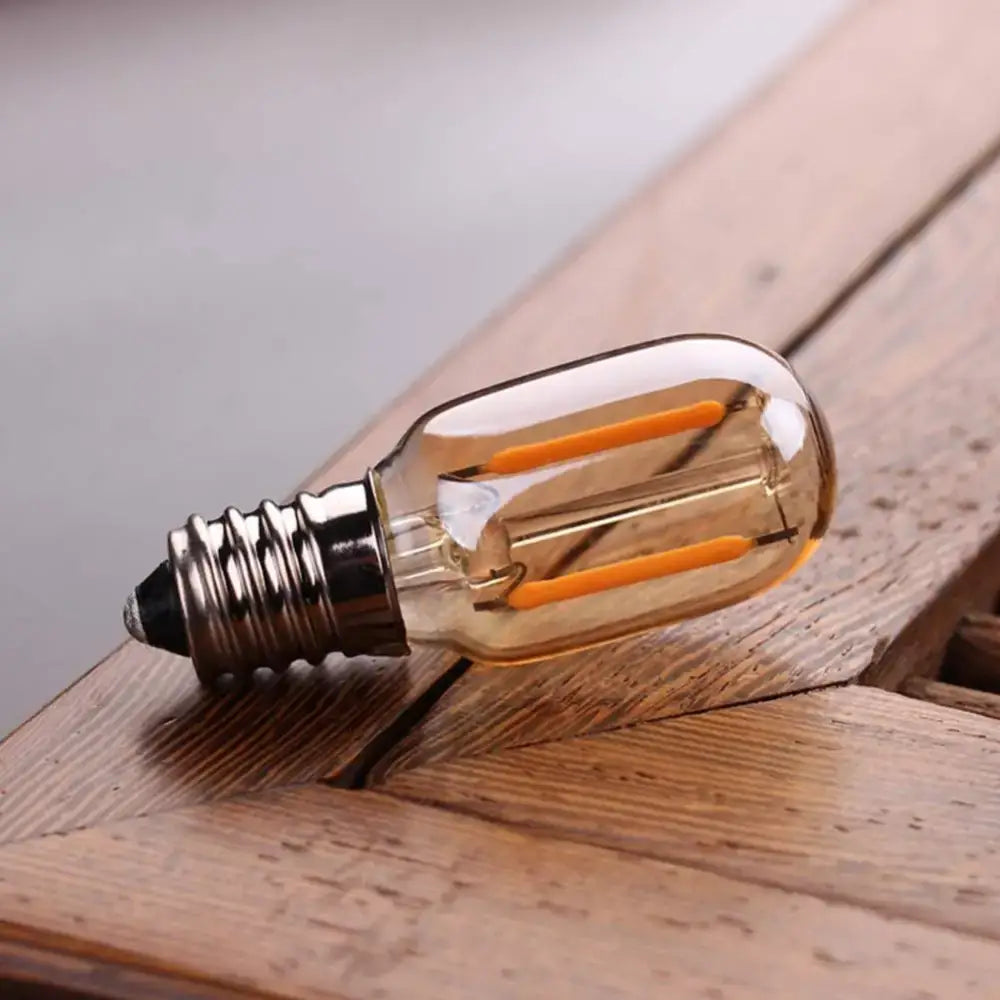 Vintage-style decorbites™ amber glass led bulb with warm white 2200k light and metallic screw base