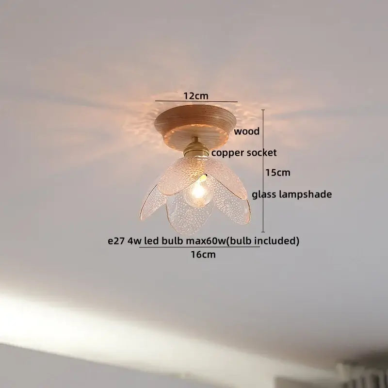 A delicate flower-shaped amber glass led ceiling light with textured finish on copper socket and wooden base for modern decor