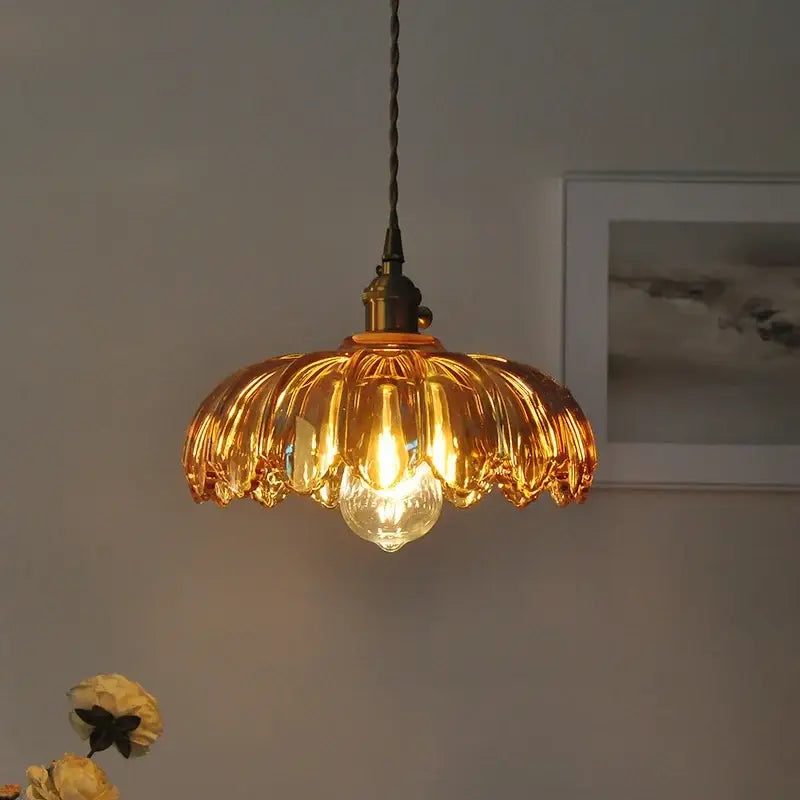 Decorbites amber glass led pendant lamp with golden petal-shaped glass and brass-finished fixture with black cord