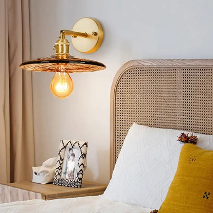 Gold-toned DecorBites amber glass led wall lamp with textured shade and exposed filament bulb for bedroom lighting