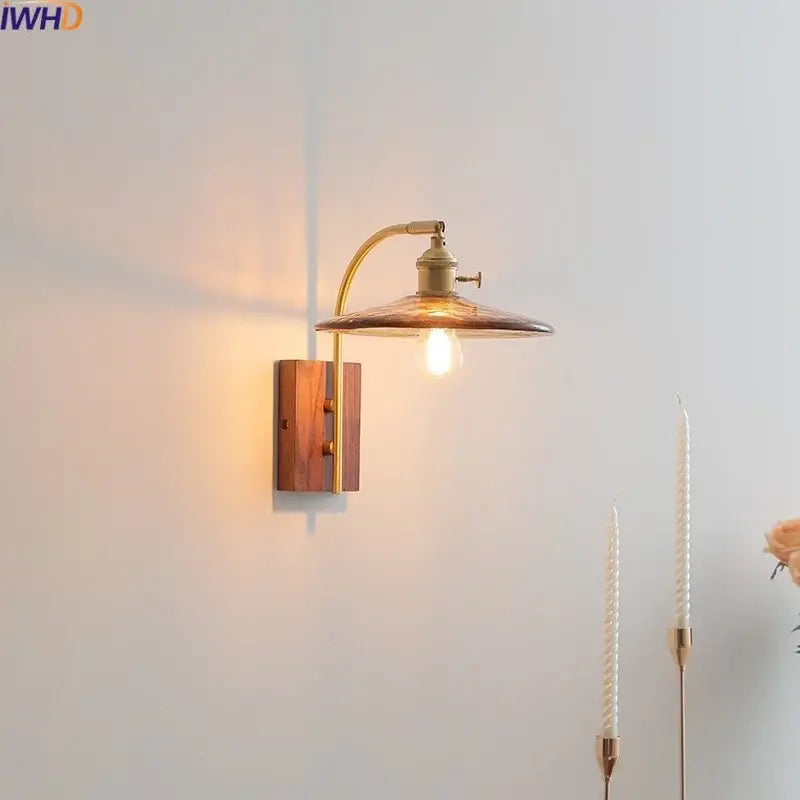 Antique brass wall lamp with warm amber glass LED shade and wooden base from DecorBites amber glass collection