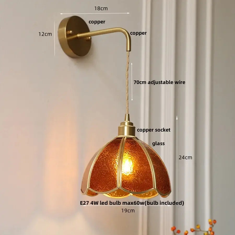 Antique brass-finished led wall light with textured amber glass shade shaped like an open flower for bedroom and staircase