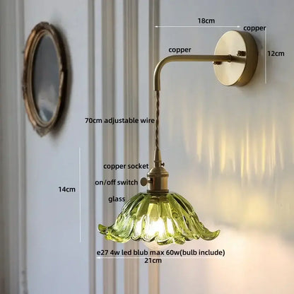 Vintage-style copper wall sconce with green petal-shaped glass shade featured in DecorBites amber glass led collection