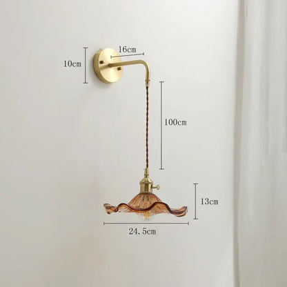 Vintage-style decorbites amber glass wall sconce with brass-finished arm and amber ruffled glass shade for indoor lighting