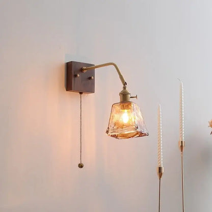 Brass-finished decorbites amber glass led wall sconce with faceted amber glass shade and adjustable arm pull chain switch