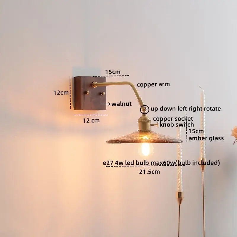 Decorbites amber glass led wall sconce with warm copper finish, walnut mounting plate, and amber glass shade with pull chain switch