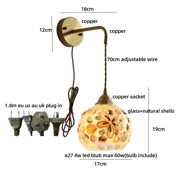 Decorbites amber glass led wall sconce with spherical amber glass shade adorned with shells and copper hardware for bedroom