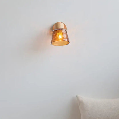 Warm amber glass LED wall sconce by DecorBites with copper metal base and pull chain switch for Nordic modern wood stairs