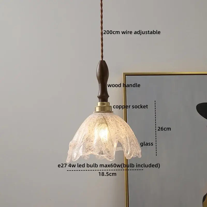 A decorbites amber glass pendant lamp featuring a delicate amber glass design with a dark wood handle for modern decor