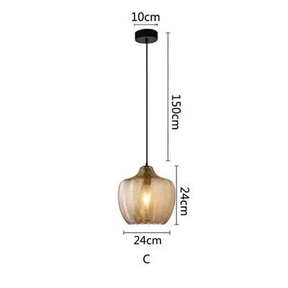 A modern decorbites amber glass pendant light with textured amber glass shade and black metal hardware for kitchen use