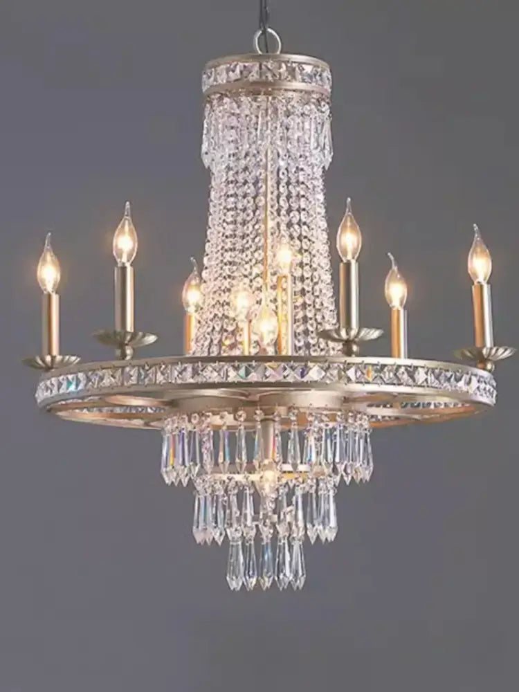 A multi-tiered decorbites american country chandelier with brushed gold finish and cascading clear crystals for dining rooms