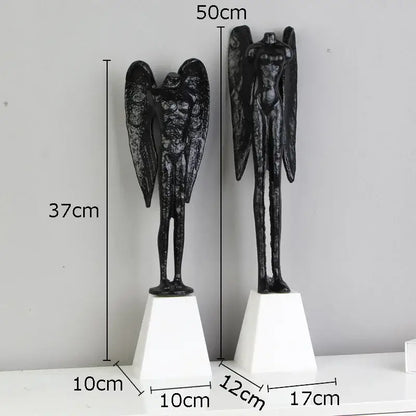 DecorBites™ black cast iron angel abstract figures sculpture with detailed wings and muscular forms on white pedestals