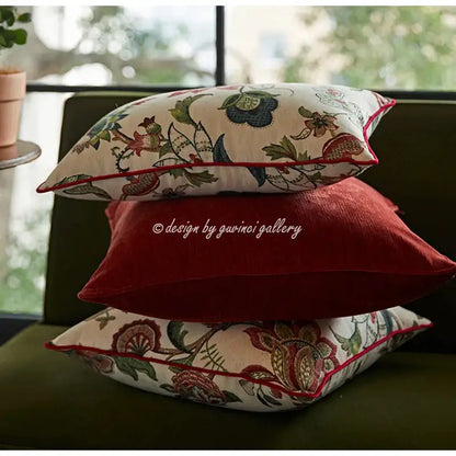 Stacked decorbites™ angel eyes lumbar pillow covers with cream base, floral embroidery, and bold red piping