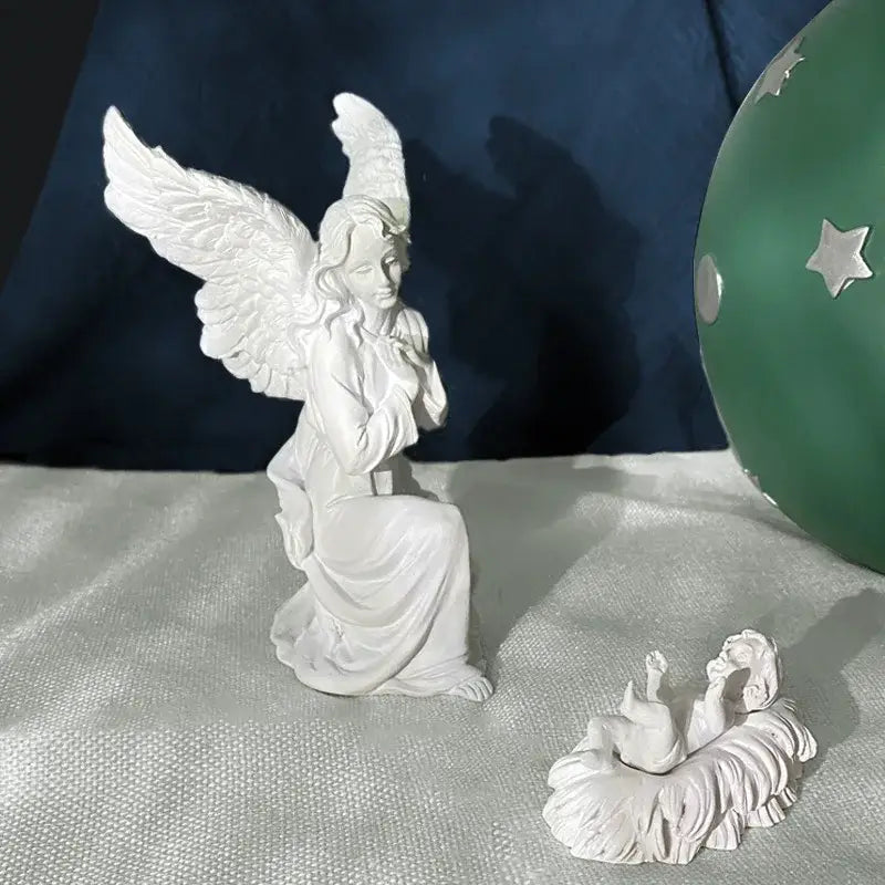 White angel figurine with detailed wings and flowing robes made of gold resin collectible statue for home decor