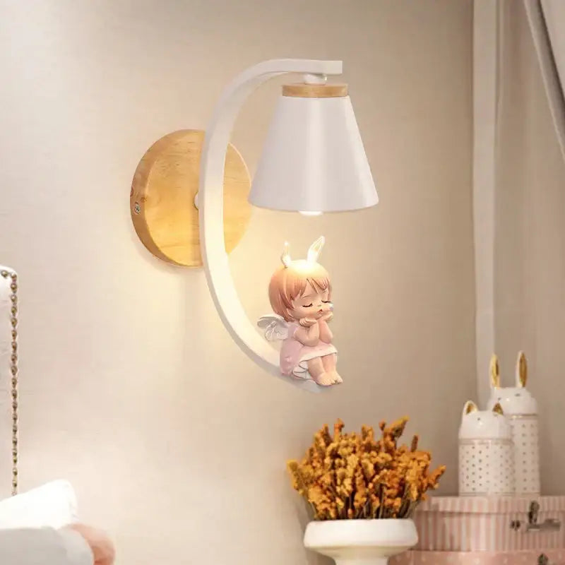 White ceramic wall sconces with wooden base and pink angel figurine for decorbites angel girl bedroom use